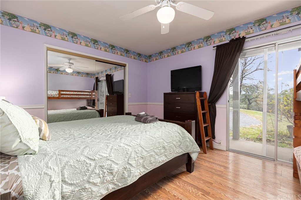 45943 Black Oak Road Coarsegold, CA 93614 - Photo 42 of 64 a bedroom with a bed and a flat tv screen on dresser