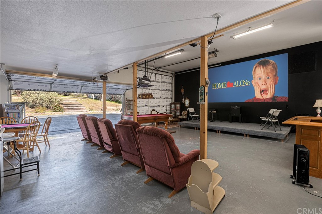 45943 Black Oak Road Coarsegold, CA 93614 - Photo 47 of 64 a living room with furniture a flat screen tv and floor to ceiling window