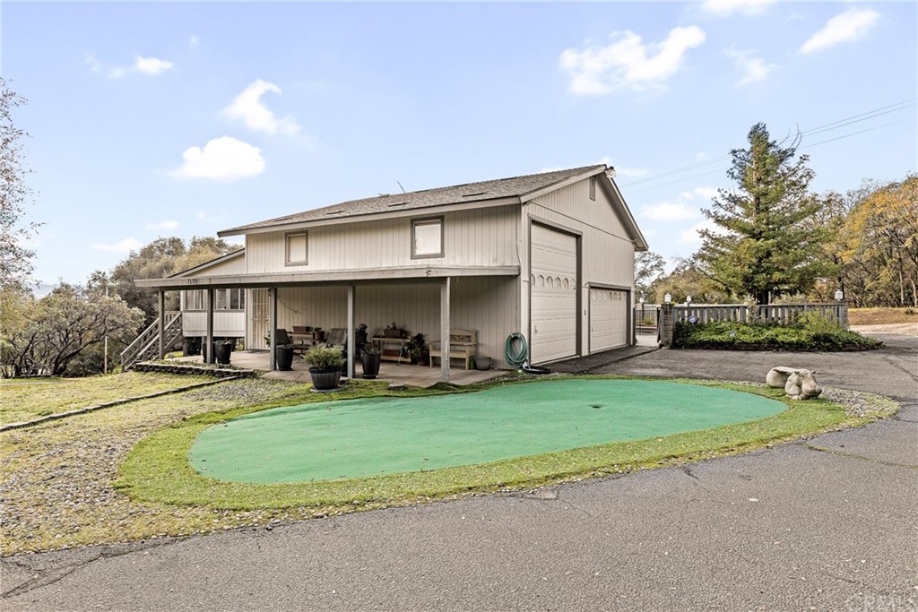 45943 Black Oak Road Coarsegold, CA 93614 - Photo 57 of 64 a view of a house with sitting area and yard