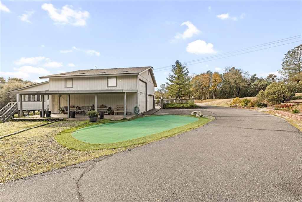 45943 Black Oak Road Coarsegold, CA 93614 - Photo 59 of 64 a view of a big house with a big yard and large trees