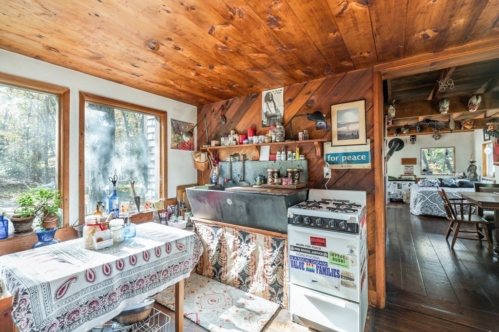 24 Paradise Road Ipswich, MA 01938 - Photo 6 of 27 a living room with furniture a flat screen tv and a floor to ceiling window