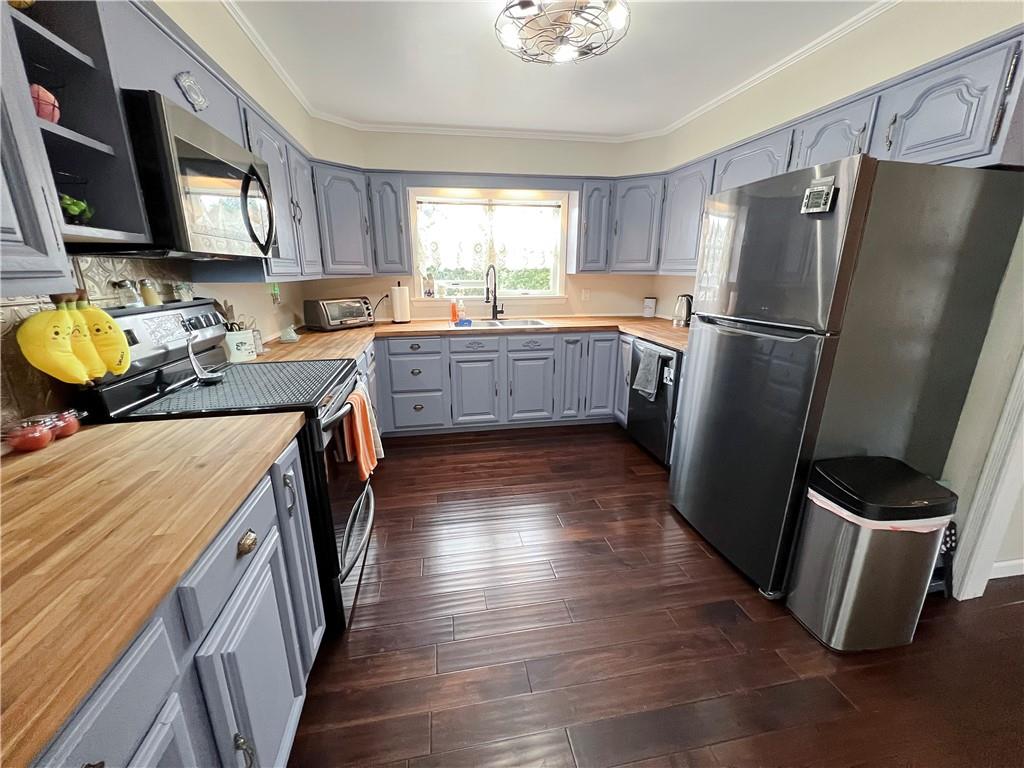 203 Delafayette Street Perryopolis, PA 15473 - Photo 13 of 37 Spacious kitchen has refinished cabinetry, new hardwood floors, new butcher block countertops, and new black stainless steel appliances.