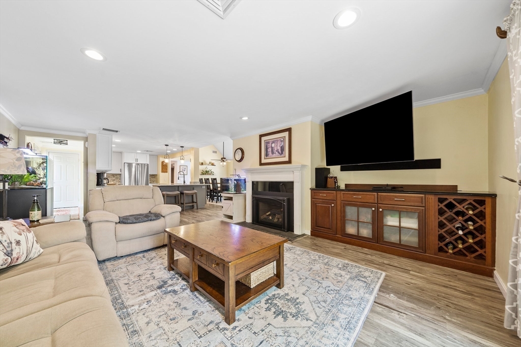 12 Richard Road Natick, MA 01760 - Photo 15 of 42 a living room with furniture a flat screen tv and a fireplace