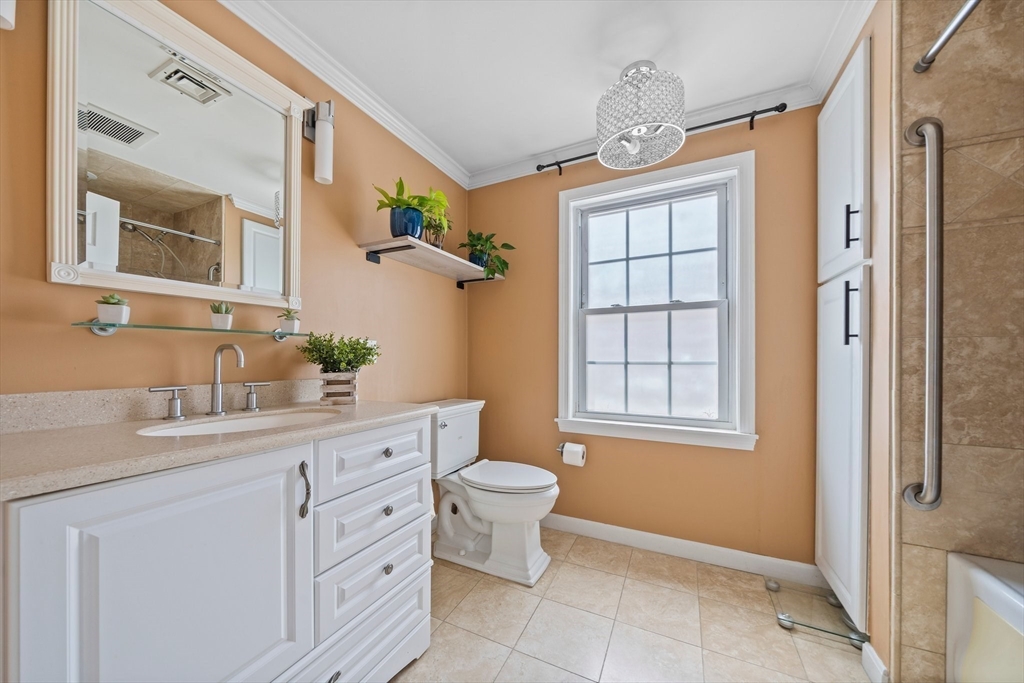12 Richard Road Natick, MA 01760 - Photo 17 of 42 a bathroom with a granite countertop sink toilet a mirror and a shower
