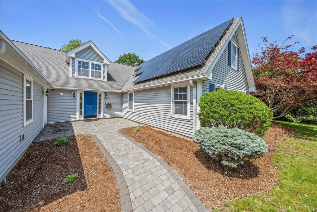 12 Richard Road Natick, MA 01760 - Photo 2 of 42 a front view of a house with a yard and potted plants