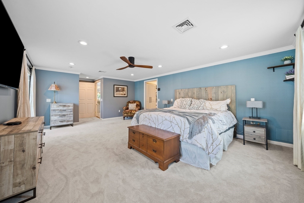 12 Richard Road Natick, MA 01760 - Photo 23 of 42 a spacious bedroom with a bed and a flat screen tv