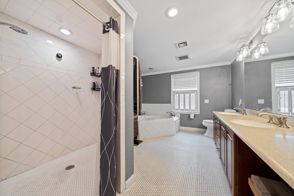 12 Richard Road Natick, MA 01760 - Photo 28 of 42 a large bathroom with a double vanity sink a large mirror and shower