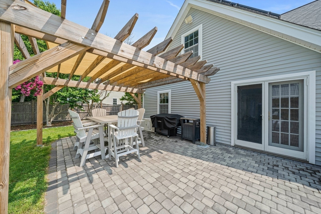 12 Richard Road Natick, MA 01760 - Photo 32 of 42 a view of a patio with table and chairs with wooden floor and fence