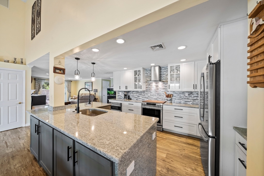 12 Richard Road Natick, MA 01760 - Photo 6 of 42 a kitchen with stainless steel appliances granite countertop a sink stove and refrigerator
