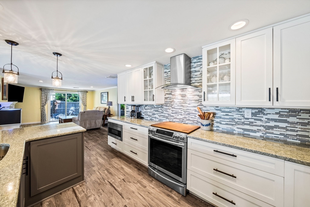12 Richard Road Natick, MA 01760 - Photo 8 of 42 a kitchen with stainless steel appliances granite countertop a stove and a sink