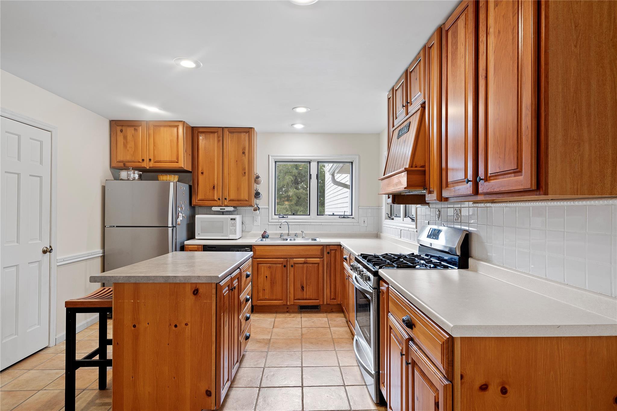 6627 Smith Road Stanfield, NC 28163 - Photo 16 of 40 a kitchen with stainless steel appliances granite countertop a stove a sink dishwasher and a refrigerator