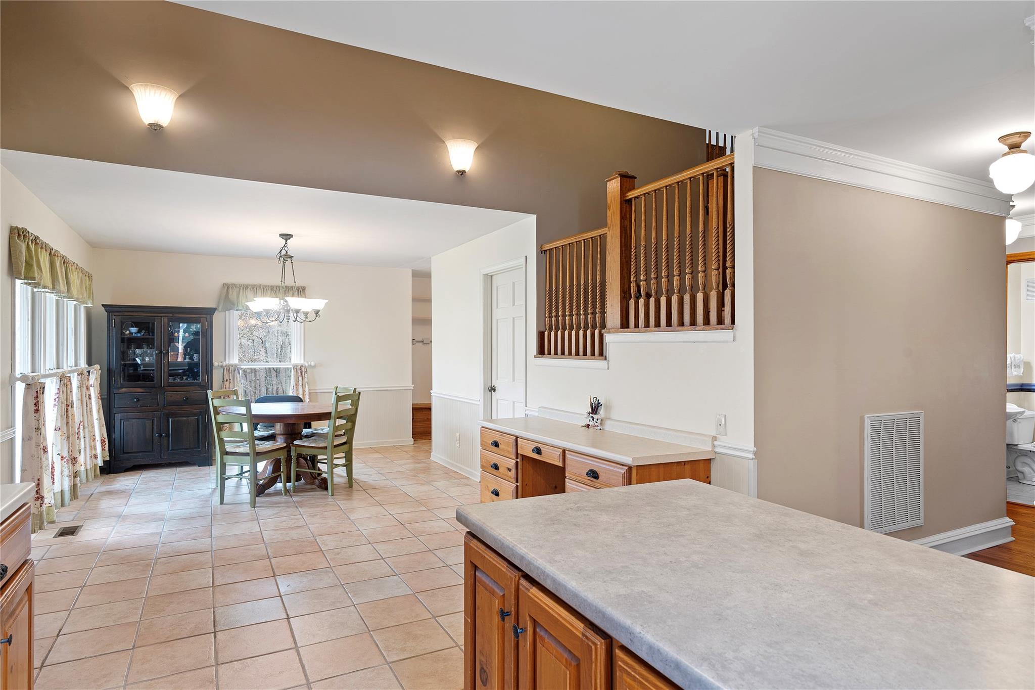6627 Smith Road Stanfield, NC 28163 - Photo 17 of 40 a open kitchen that has a stove a sink dishwasher a dining table and chairs with wooden floor