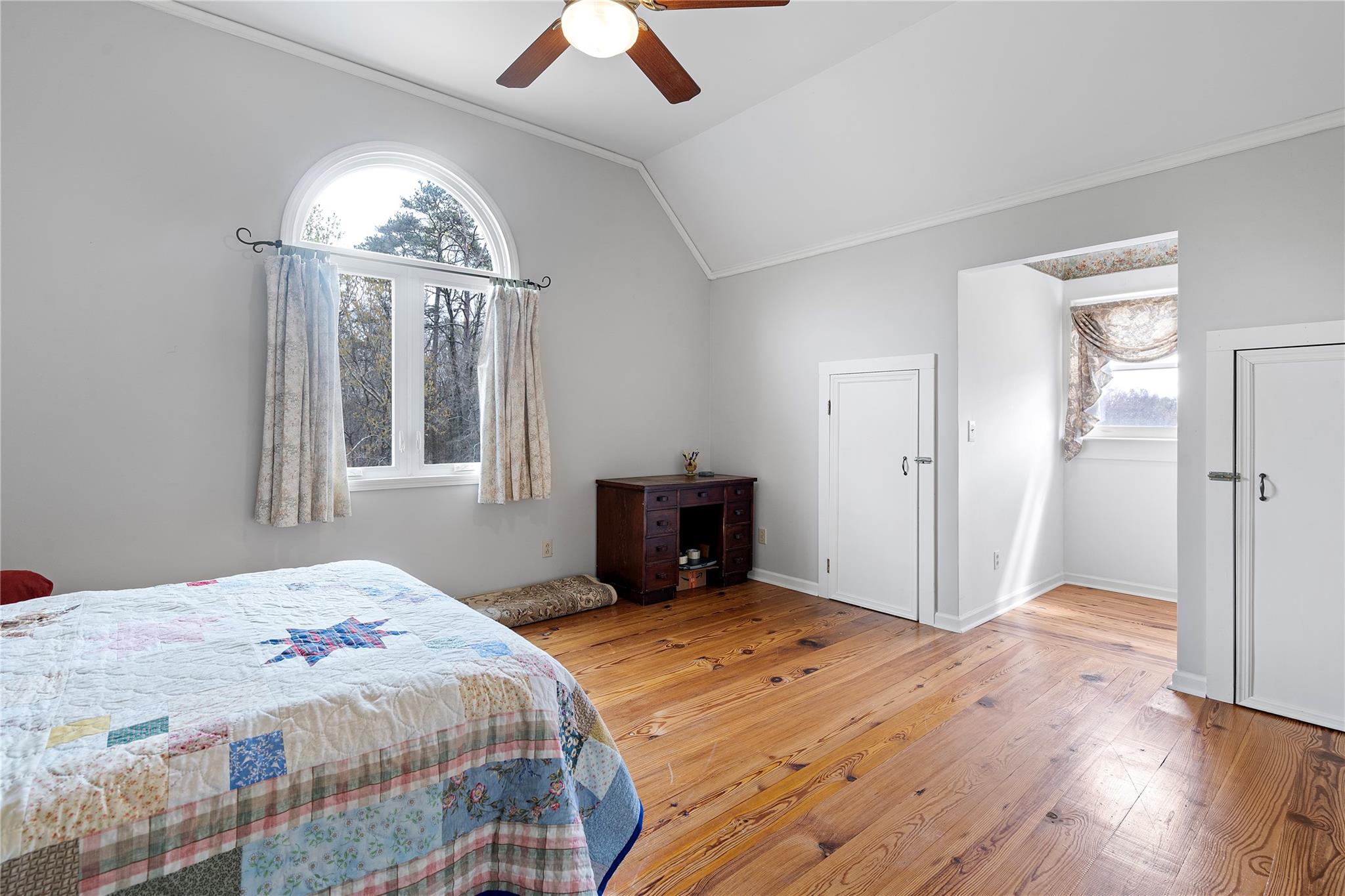 6627 Smith Road Stanfield, NC 28163 - Photo 21 of 40 a bedroom with a bed and a chandelier
