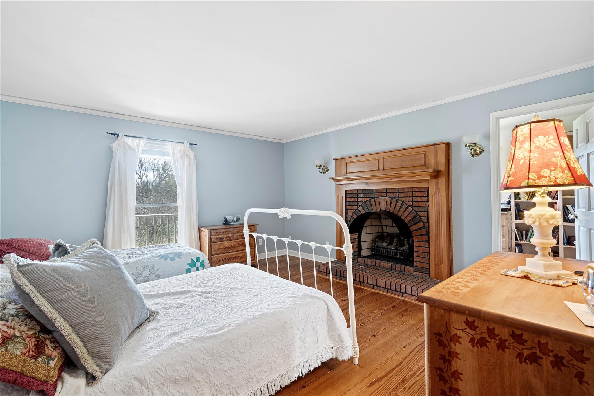 6627 Smith Road Stanfield, NC 28163 - Photo 8 of 40 a bedroom with a bed and a fireplace