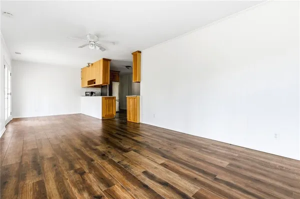 a view of a room with wooden floor