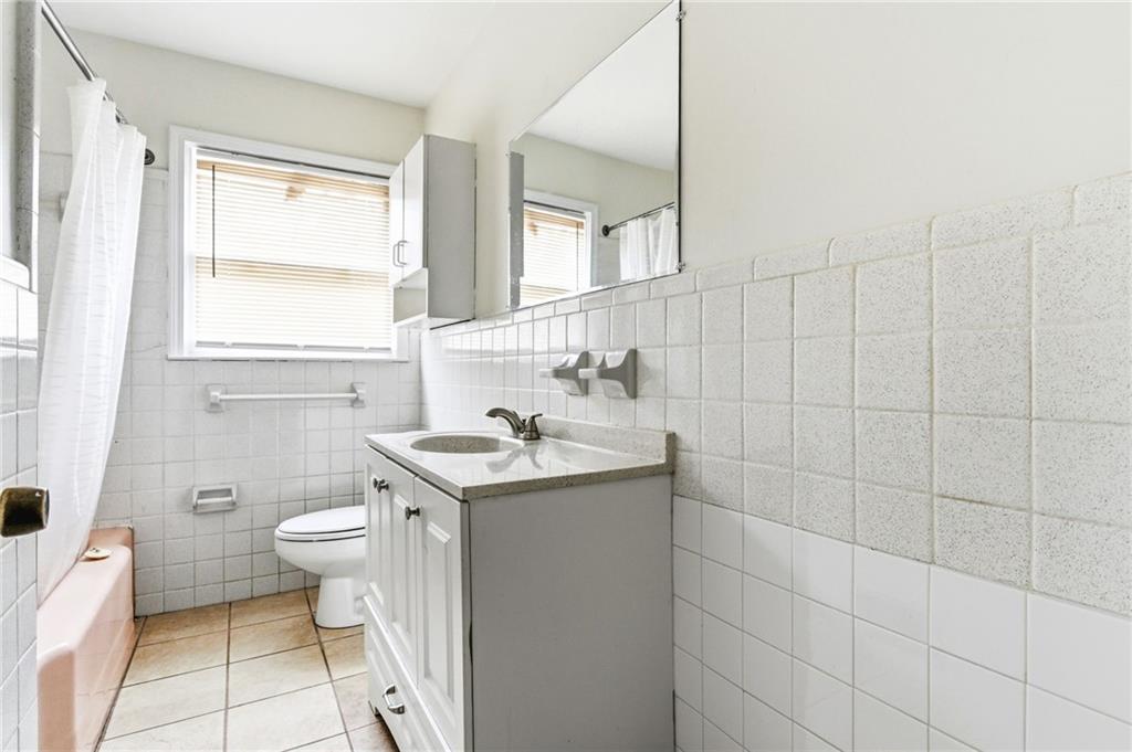 45 Chaffin Road Roswell, GA 30075 - Photo 21 of 26 a bathroom with a granite countertop sink a toilet and a mirror