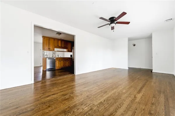 a view of empty room with wooden floor and cabinet