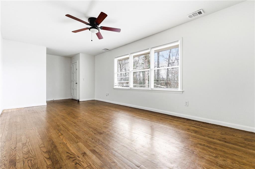 45 Chaffin Road Roswell, GA 30075 - Photo 6 of 26 an empty room with wooden floor and windows