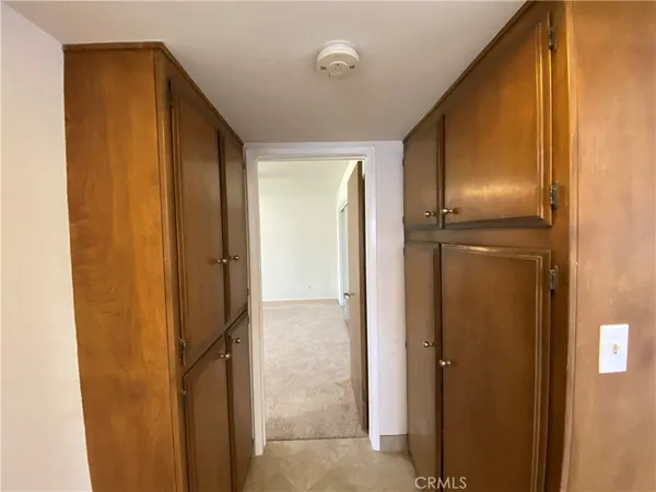 an empty room with closet and windows