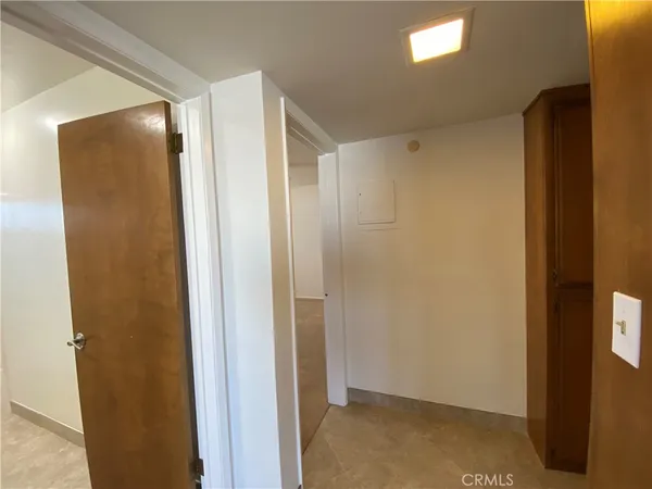 an empty room with a ceiling fan and a window