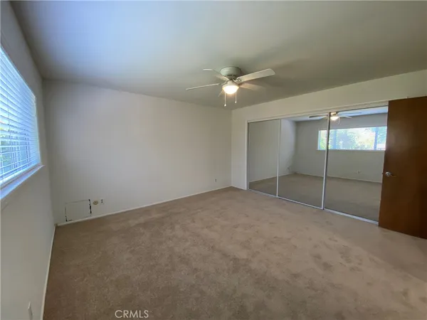 a bathroom with a granite countertop sink a mirror and shower