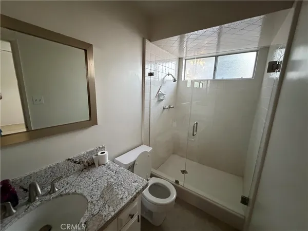 an empty room with closet and a ceiling fan