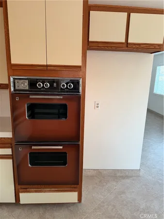 a stove top oven sitting inside of a kitchen