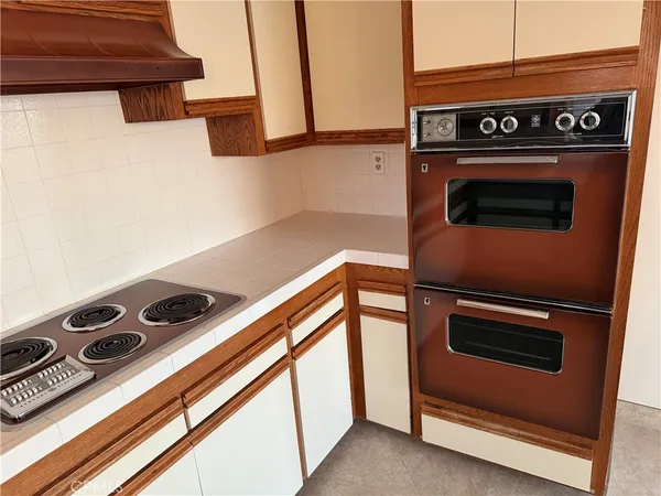 a close up of a sink a stove and a refrigerator
