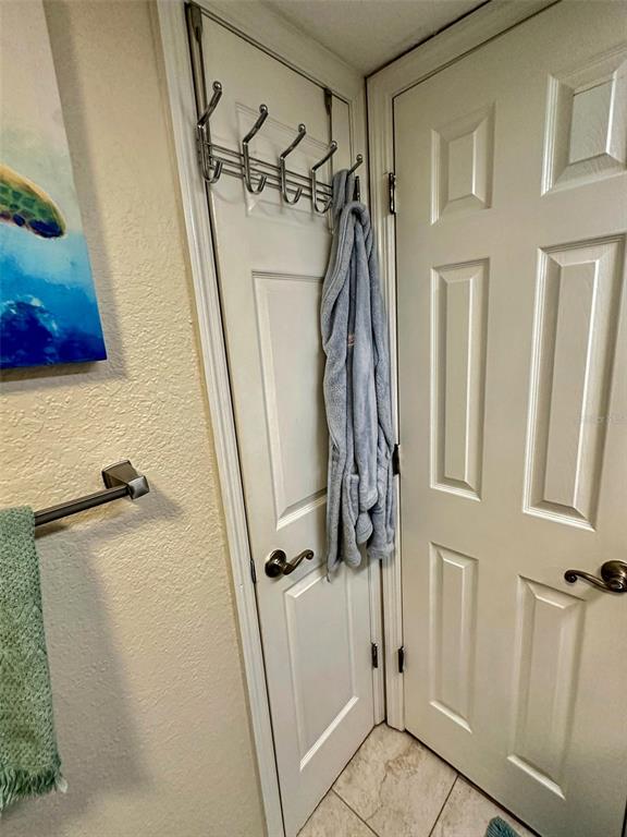 8911 Blind Pass Road, Unit 220 St. Pete Beach, FL 33706 - Photo 46 of 67 a bathroom with a tub and shower