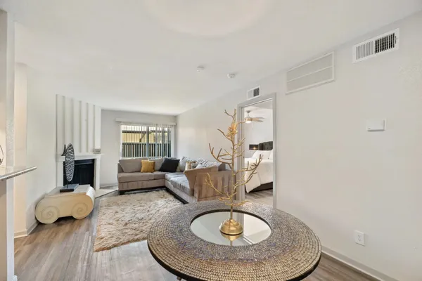 a living room with furniture and a wooden floor