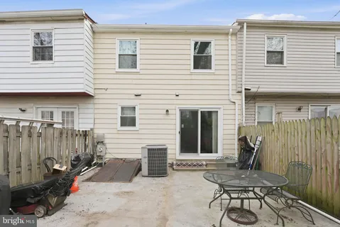 a view of a house with backyard and a chair