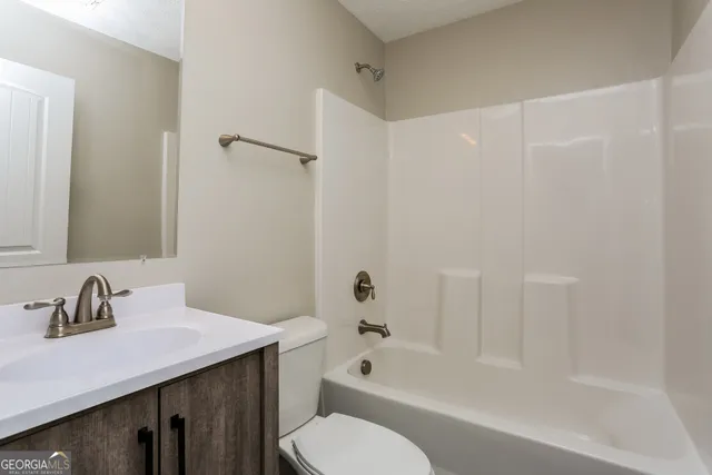 a bathroom with a sink a toilet and a bathtub