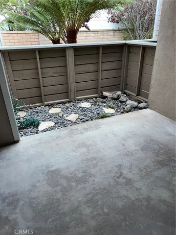 a view of wooden house with a large tree