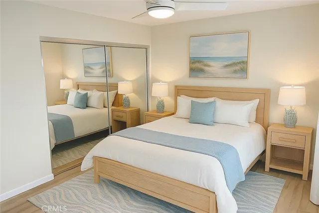 a bedroom with two beds and painting on the wall