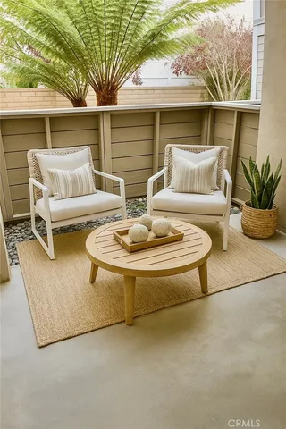 a view of a patio with couches table and chairs and potted plants