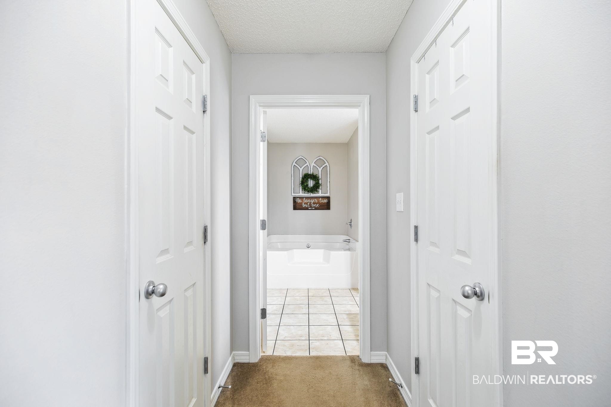 28246 Turkey Branch Drive Daphne, AL 36526 - Photo 21 of 41 Hall with light tile patterned flooring and a textured ceiling