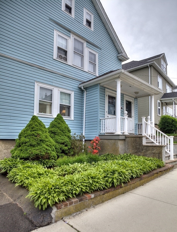 44 Cottage Park Road Winthrop, MA 02152 - Photo 4 of 39 a front view of a house with a yard and potted plants