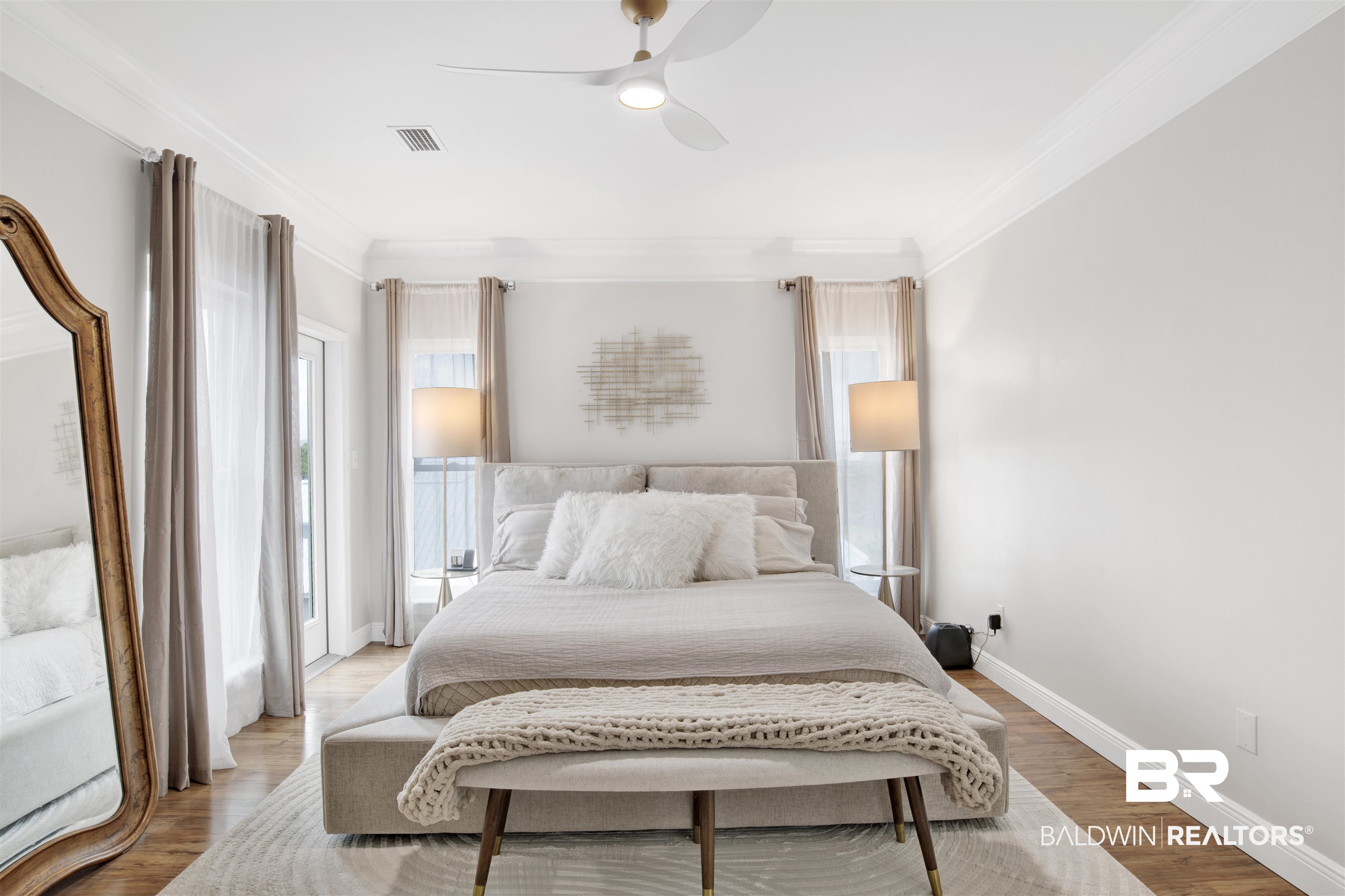 30351 River Road Orange Beach, AL 36561 - Photo 16 of 44 Spacious room featuring wood-finish flooring, white crown molding, and a contemporary ceiling fan
