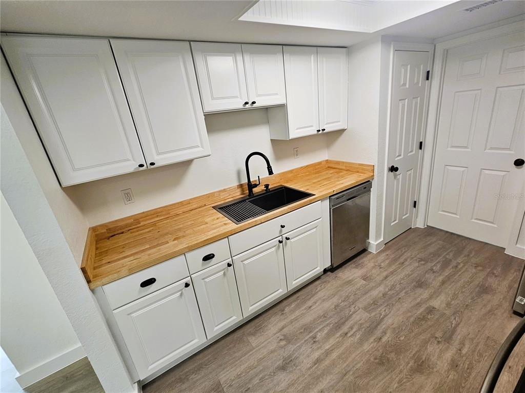12218 Shadow Ridge Boulevard Hudson, FL 34669 - Photo 14 of 34 a kitchen with granite countertop white cabinets and a sink