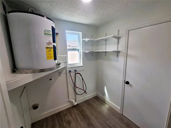 a view of a kitchen with a sink and dishwasher a refrigerator with wooden floor