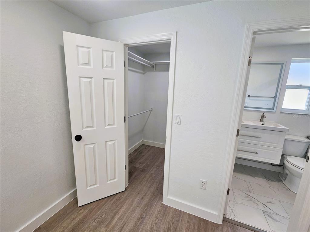 12218 Shadow Ridge Boulevard Hudson, FL 34669 - Photo 19 of 34 a view of a hallway with wooden floor and closet