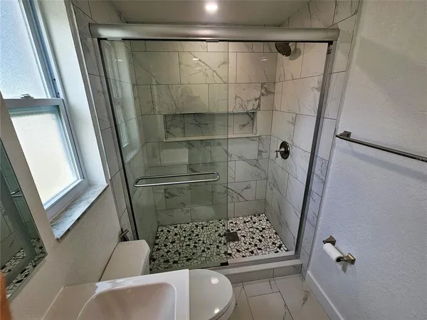 a bathroom with a sink toilet and a mirror