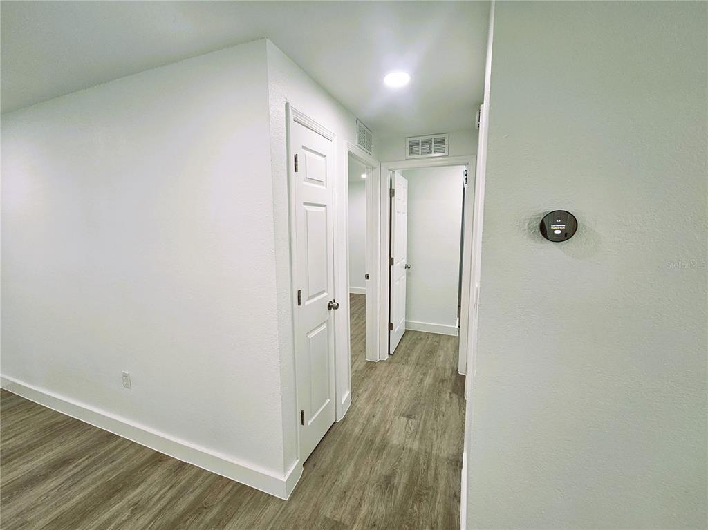 12218 Shadow Ridge Boulevard Hudson, FL 34669 - Photo 24 of 34 a view of a hallway with wooden floor