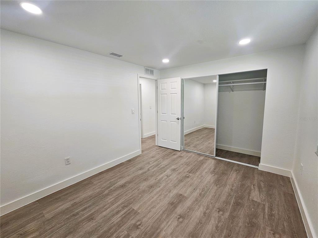 12218 Shadow Ridge Boulevard Hudson, FL 34669 - Photo 25 of 34 a view of an empty room with wooden floor and closet