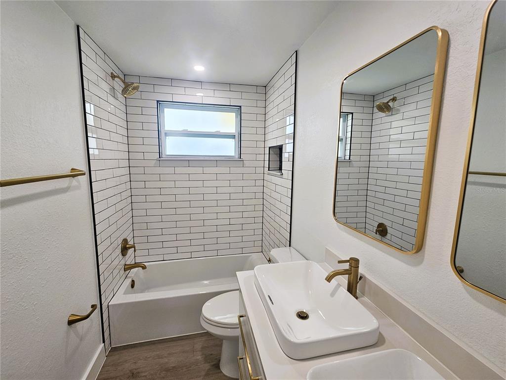 12218 Shadow Ridge Boulevard Hudson, FL 34669 - Photo 28 of 34 a bathroom with a sink a toilet and shower