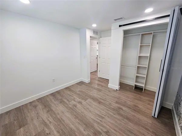 a room with a wooden floor and entryway