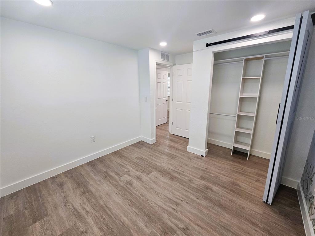 12218 Shadow Ridge Boulevard Hudson, FL 34669 - Photo 29 of 34 a view of an empty room with wooden floor and closet