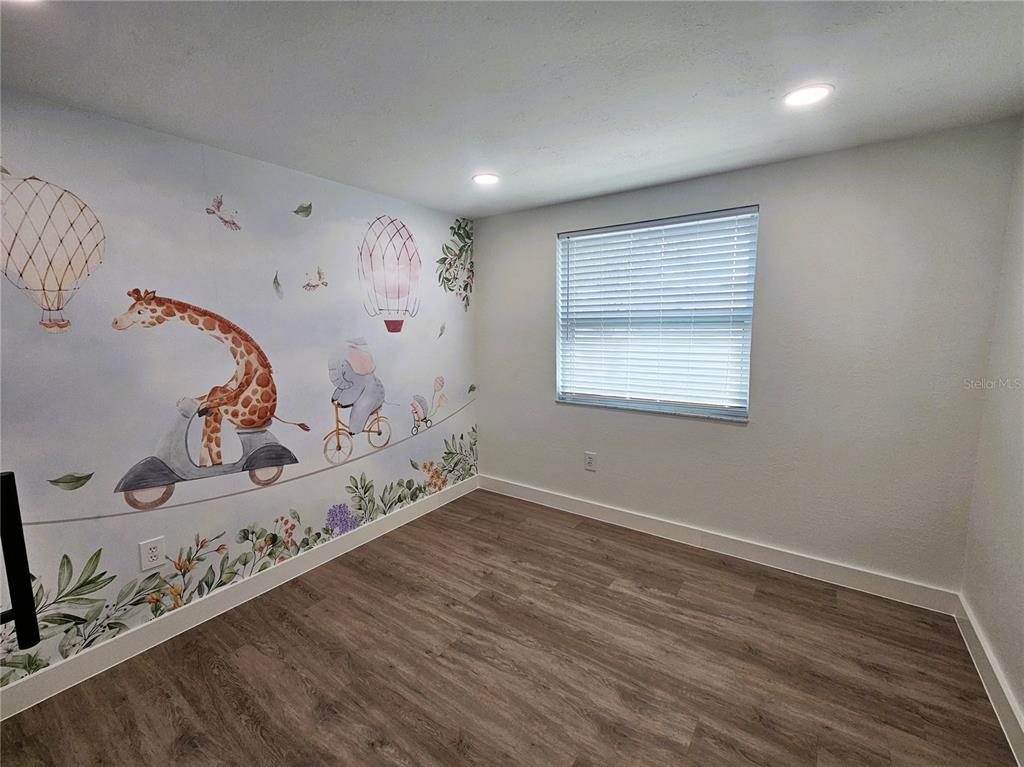 12218 Shadow Ridge Boulevard Hudson, FL 34669 - Photo 30 of 34 a room with a wooden floor and entryway