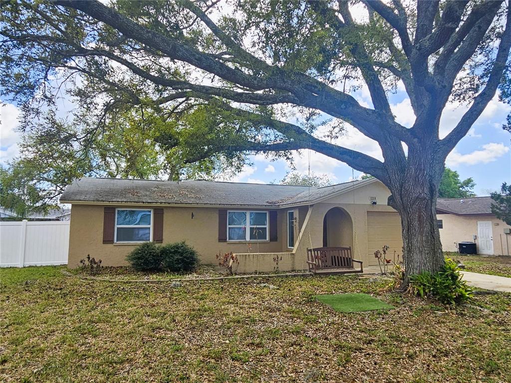 12218 Shadow Ridge Boulevard Hudson, FL 34669 - Photo 3 of 34 a front view of a house with garden