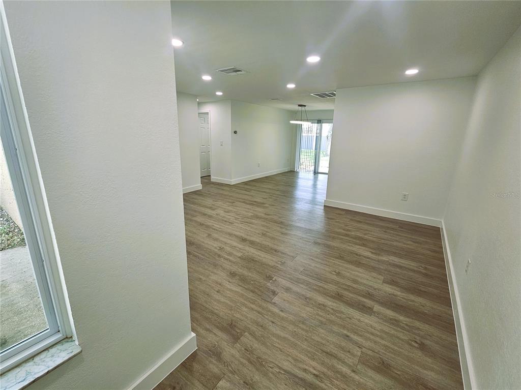 12218 Shadow Ridge Boulevard Hudson, FL 34669 - Photo 7 of 34 wooden floor in an empty room with a window